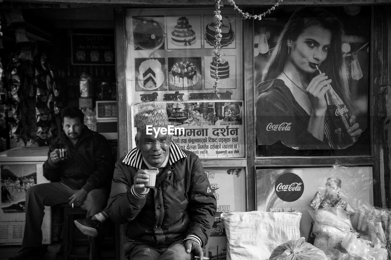 PEOPLE AT STORE WITH TEXT IN BACKGROUND