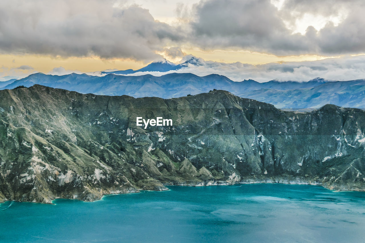 SCENIC VIEW OF SEA BY MOUNTAIN AGAINST SKY