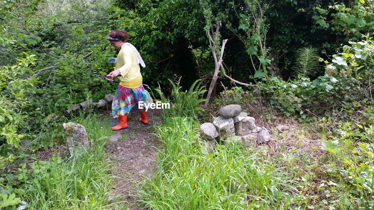 REAR VIEW OF CHILD WORKING ON GRASS