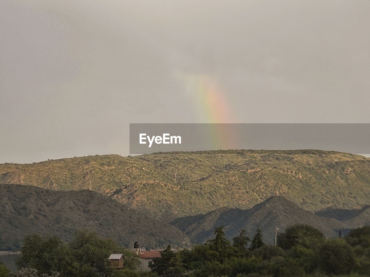 RAINBOW OVER MOUNTAINS AGAINST SKY