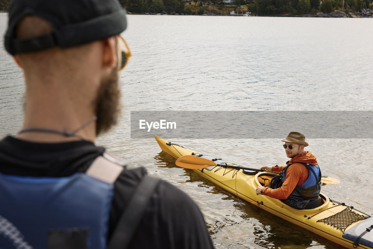 High angle view of man sitting in kayak on water