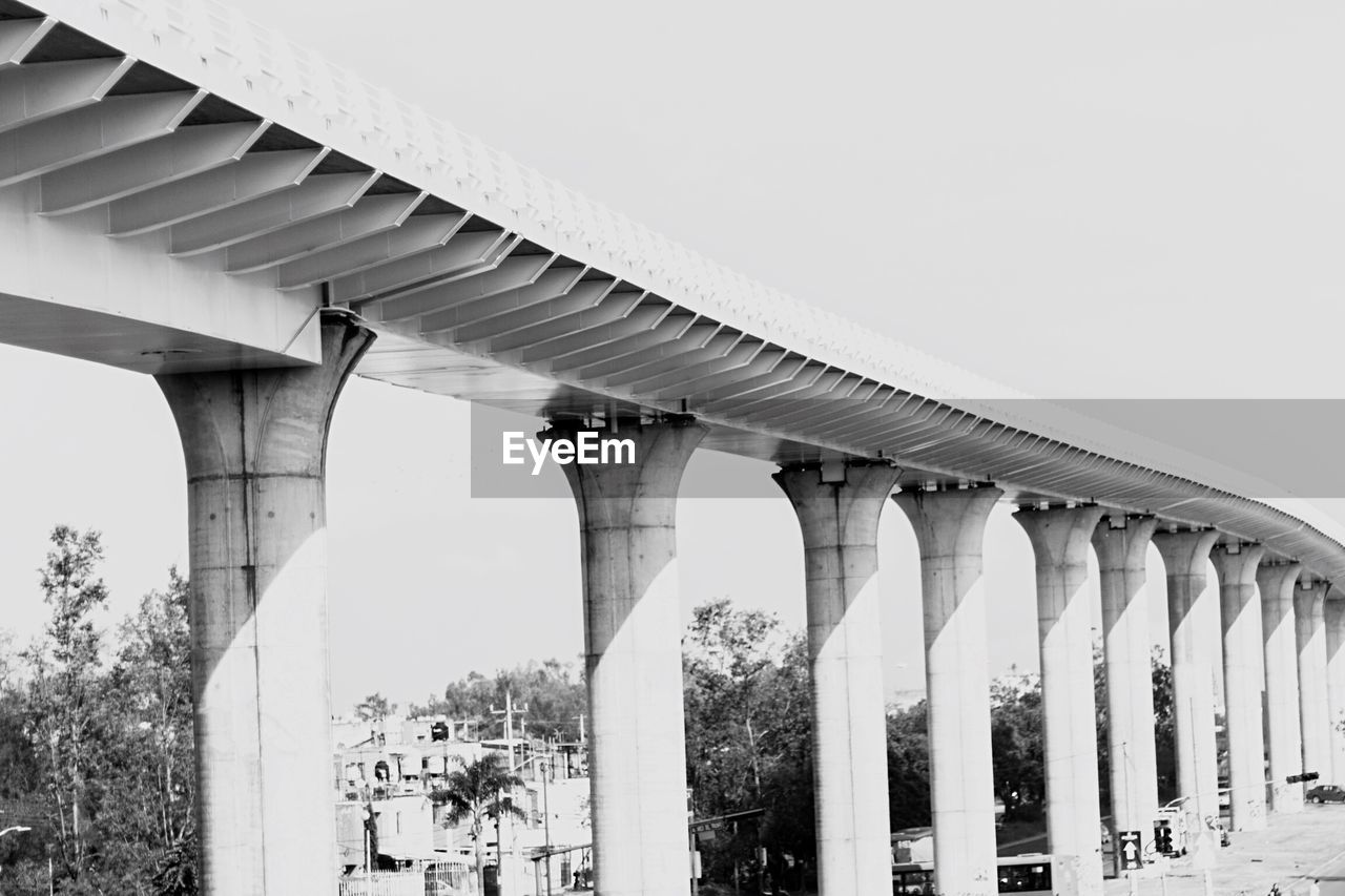 LOW ANGLE VIEW OF BRIDGE BELOW SHOT OF CABLES AGAINST CLEAR SKY