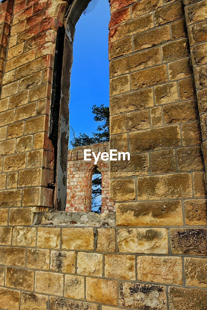 Low angle view of window at old ruins