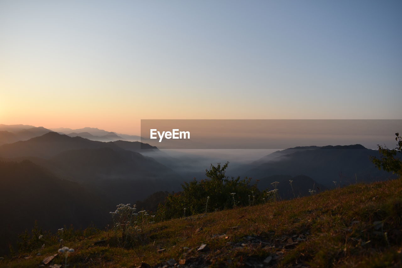 SCENIC VIEW OF MOUNTAINS AGAINST SKY DURING SUNSET