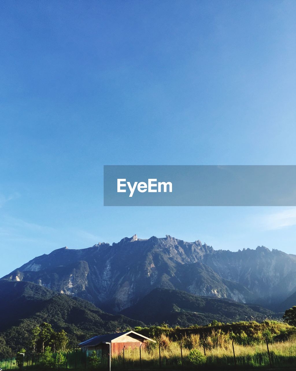 Scenic view of mountains against blue sky