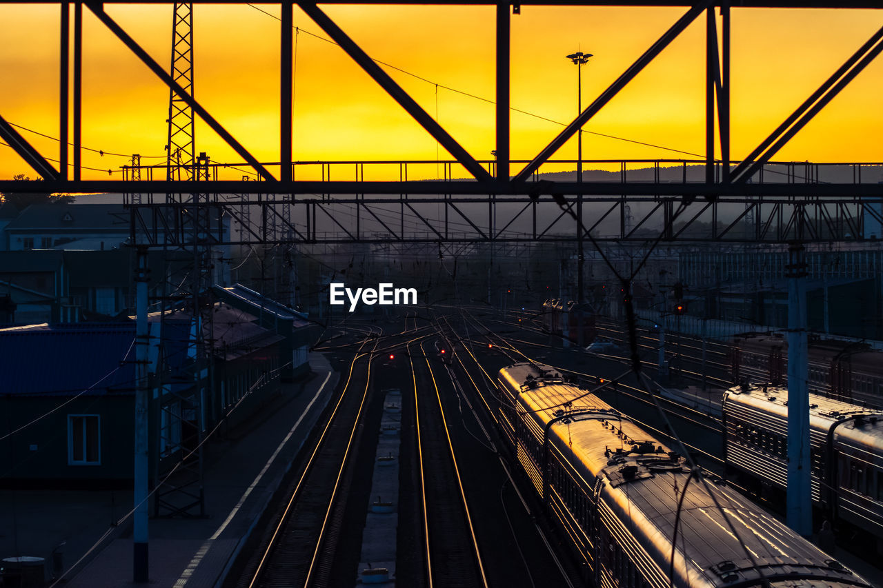 High angle view of train at railroad station during sunset