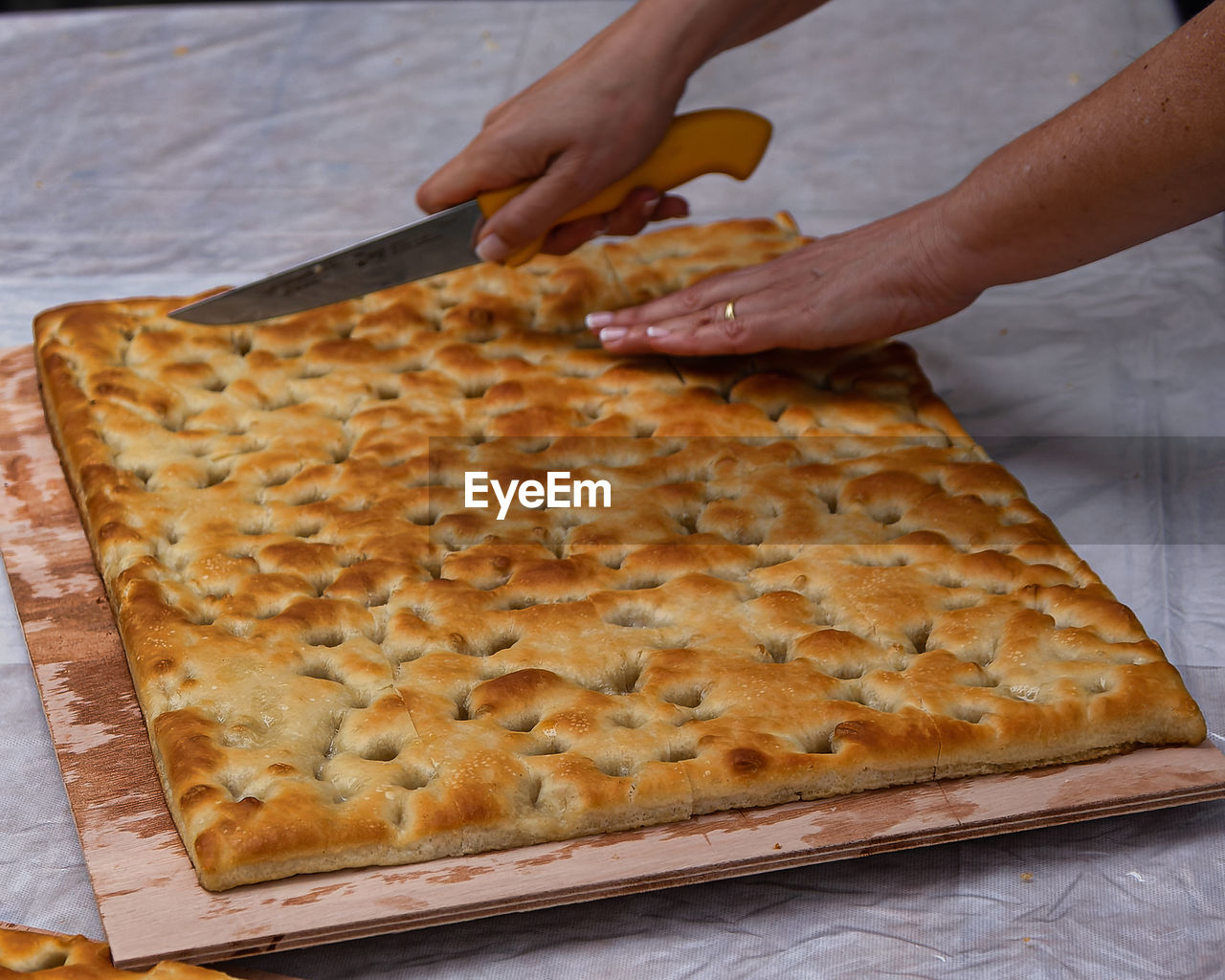 Women cut the recco focaccia