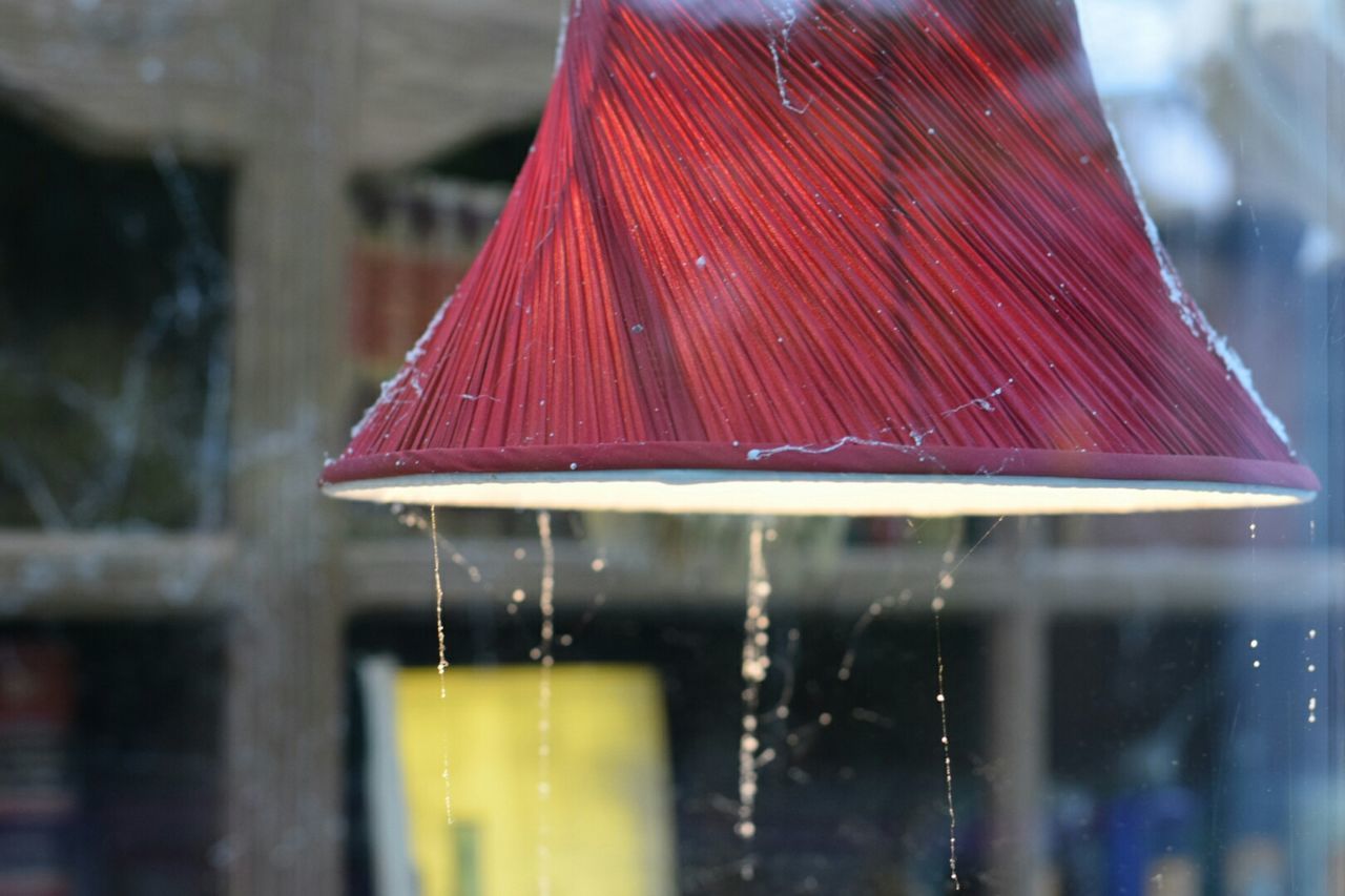 CLOSE-UP OF RED OBJECT ON WHITE SURFACE