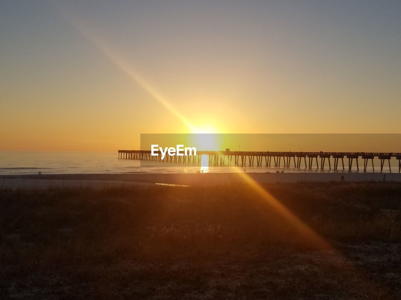 SCENIC VIEW OF SUNSET OVER SEA