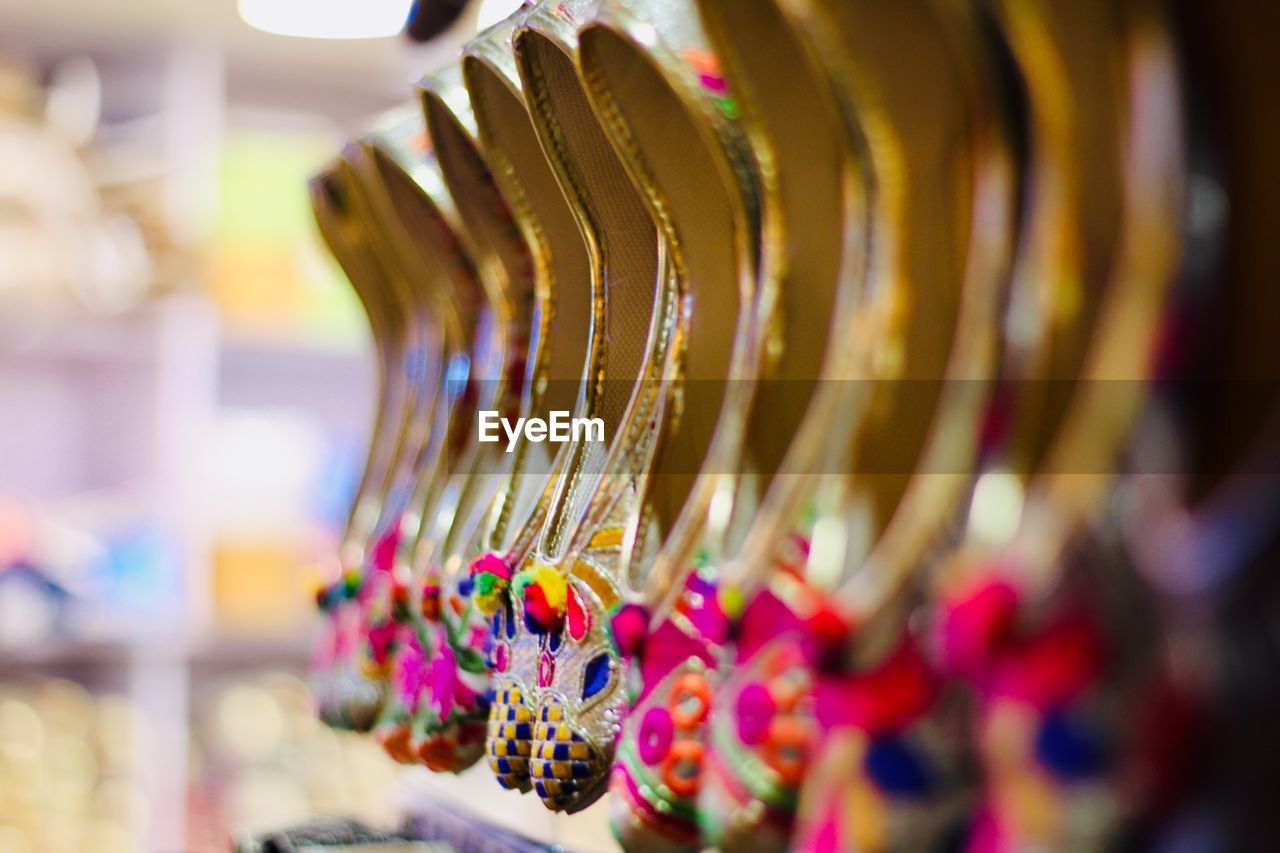 Close-up of multi colored shoe for sale in market