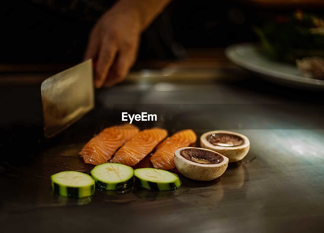 CLOSE-UP OF PERSON PREPARING FOOD