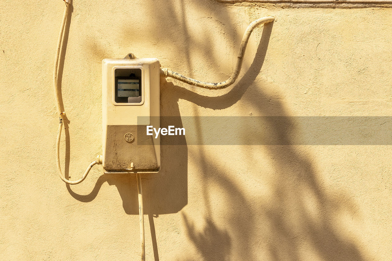 CLOSE-UP OF TELEPHONE BOOTH ON WALL