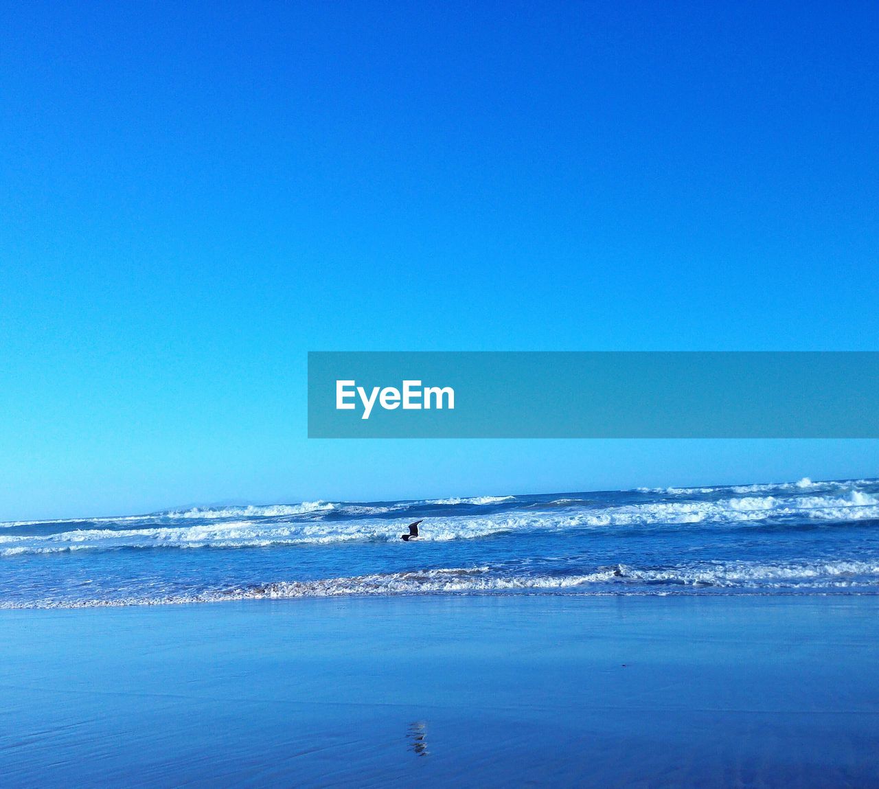 Scenic view of calm sea against clear sky