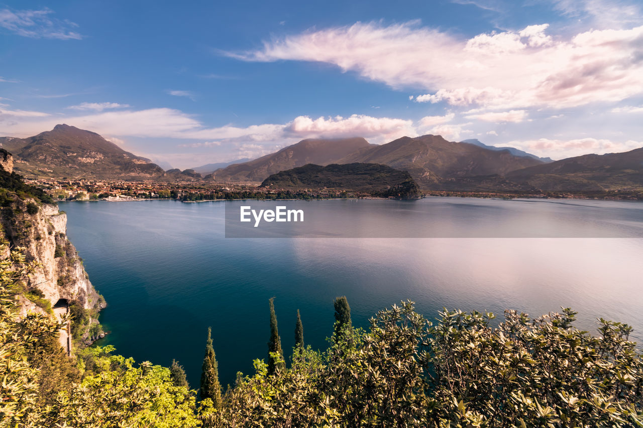 Scenic view of lake by mountains against sky