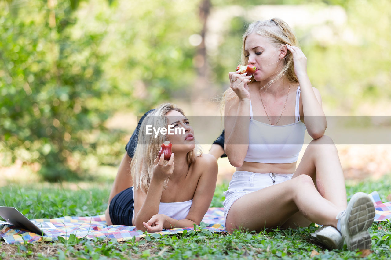 Young women eating fruits at park