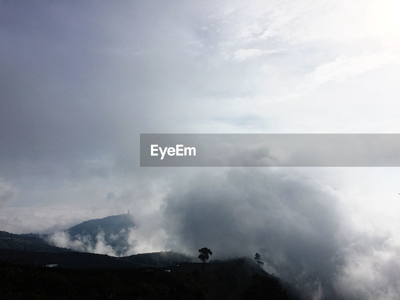 LOW ANGLE VIEW OF CLOUDS OVER MOUNTAIN