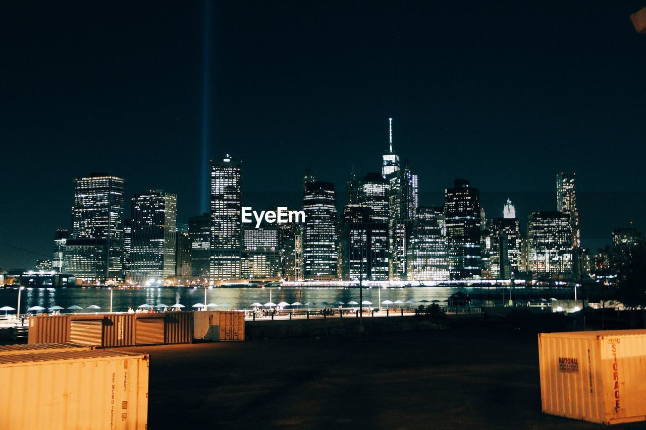 Illuminated cityscape against sky at night