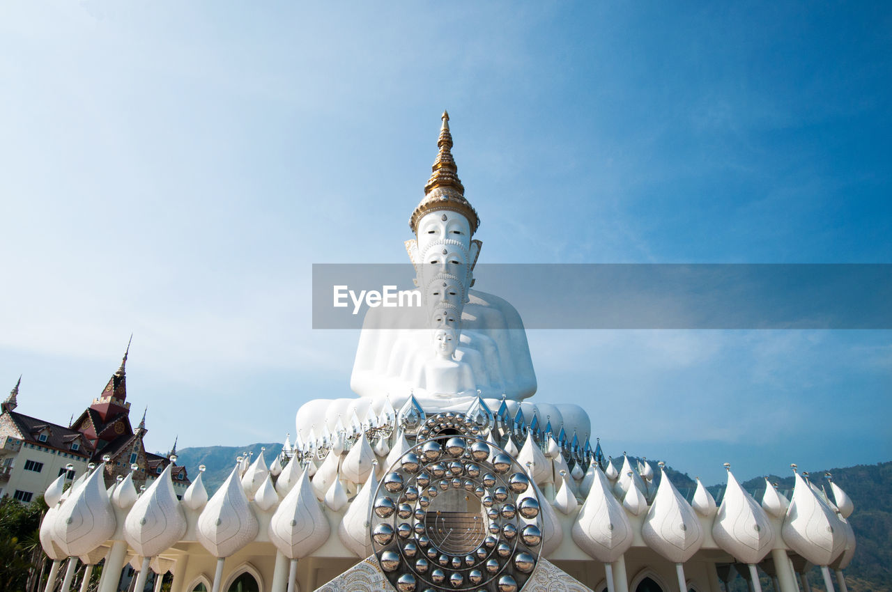 Low angle view of buddha statues at wat pha son kaew against sky