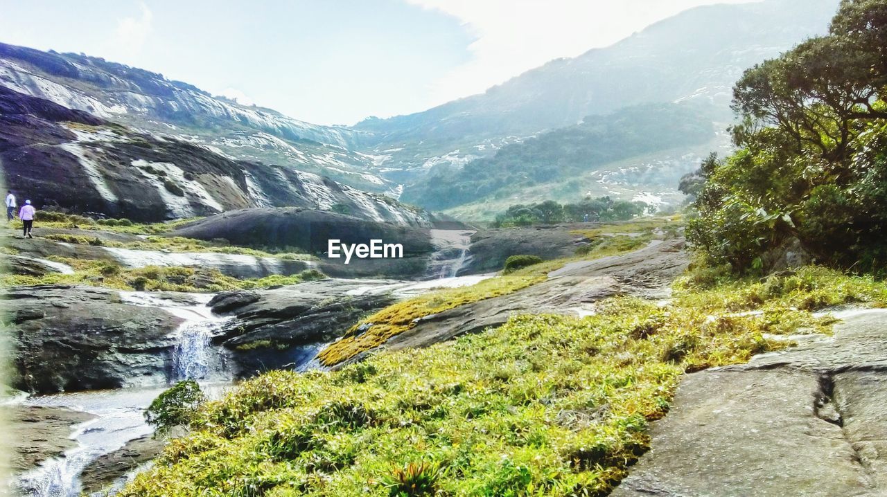 Scenic view of river amidst mountains against sky