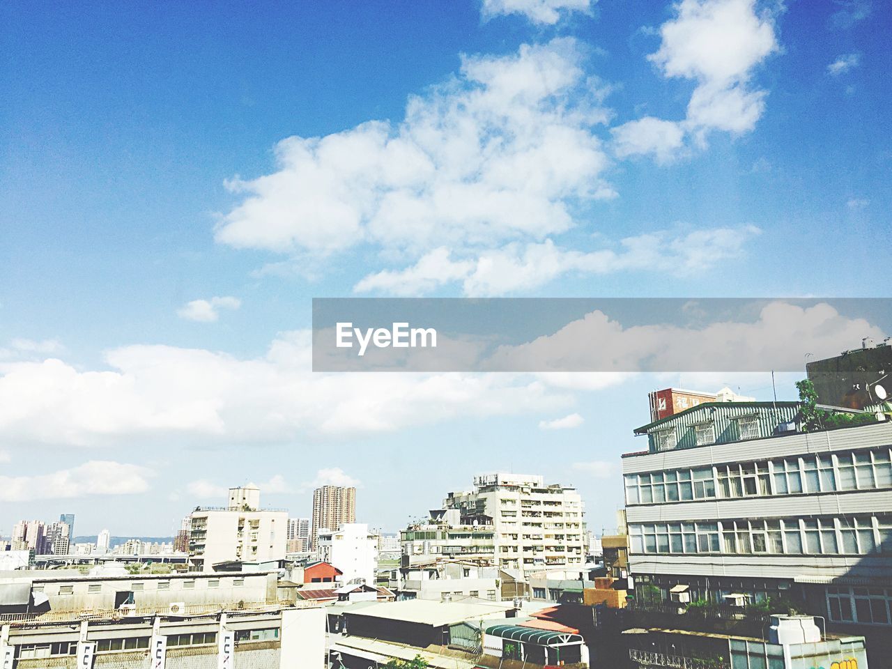 VIEW OF BUILDINGS AGAINST CLOUDY SKY