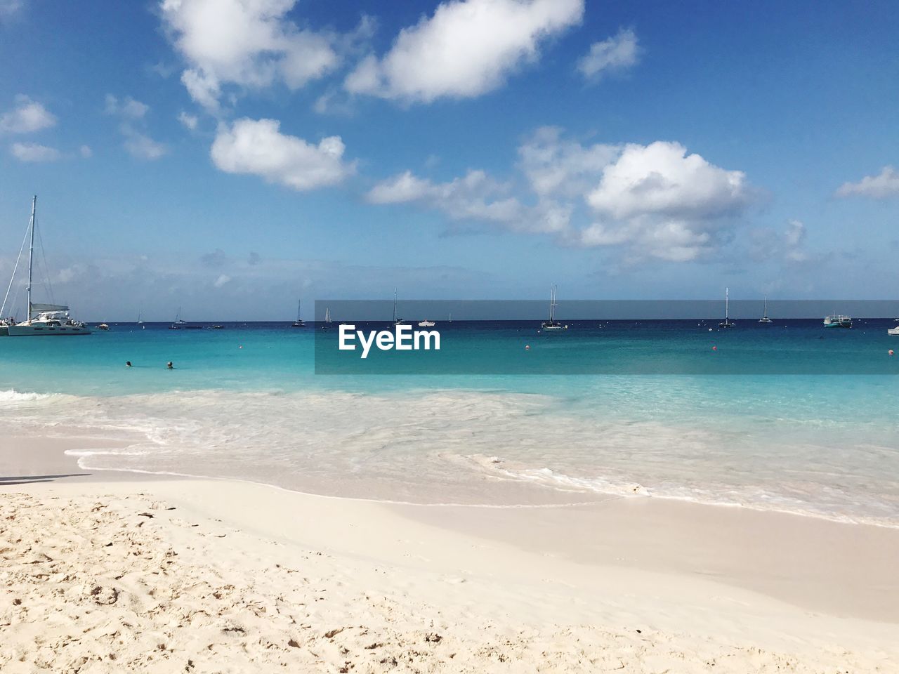 Scenic view of beach against blue sky