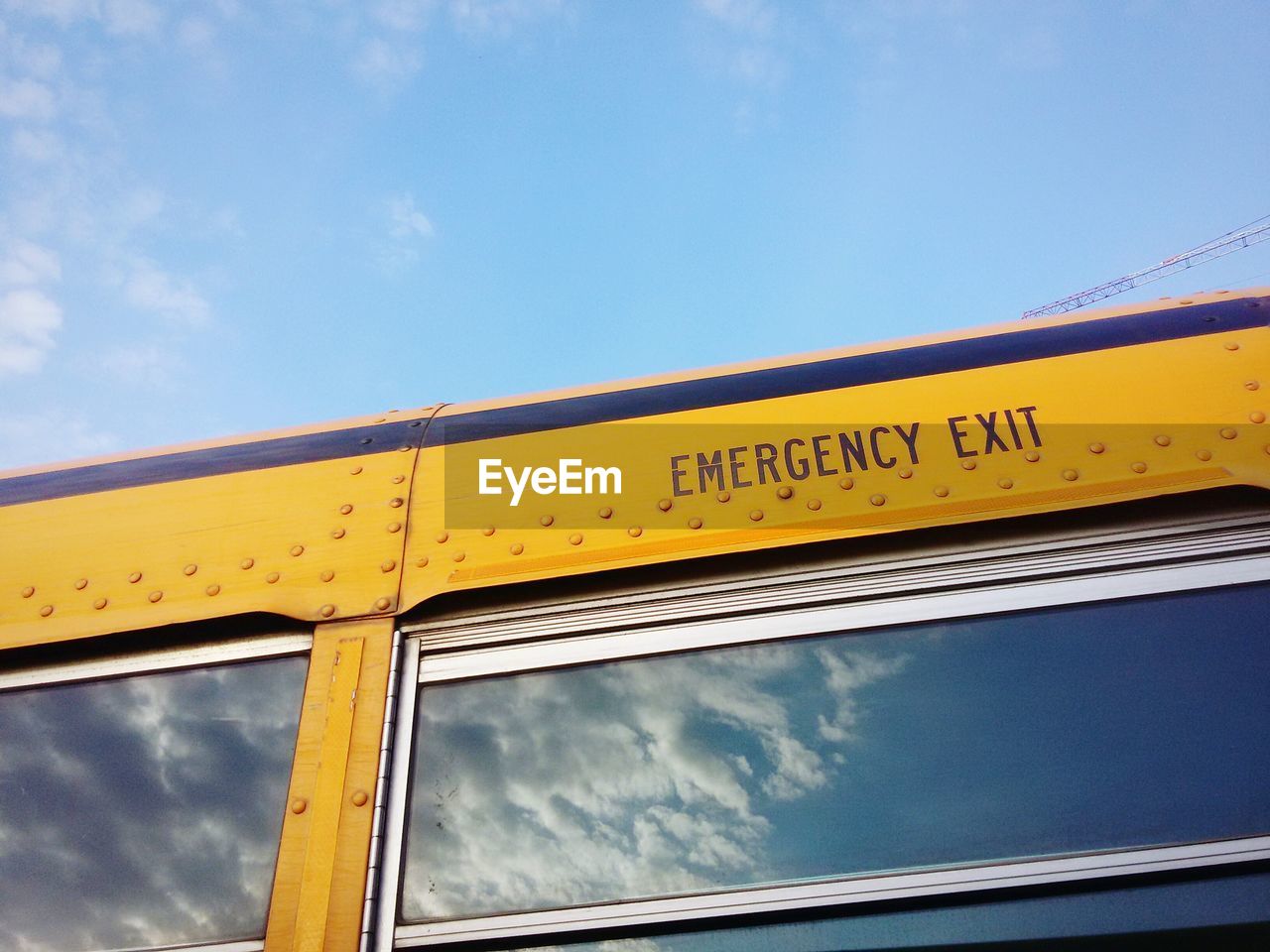 Low angle view of text on bus against sky