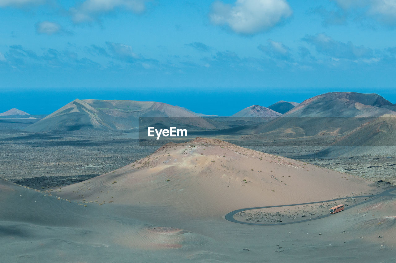 Scenic view of road at desert against sky