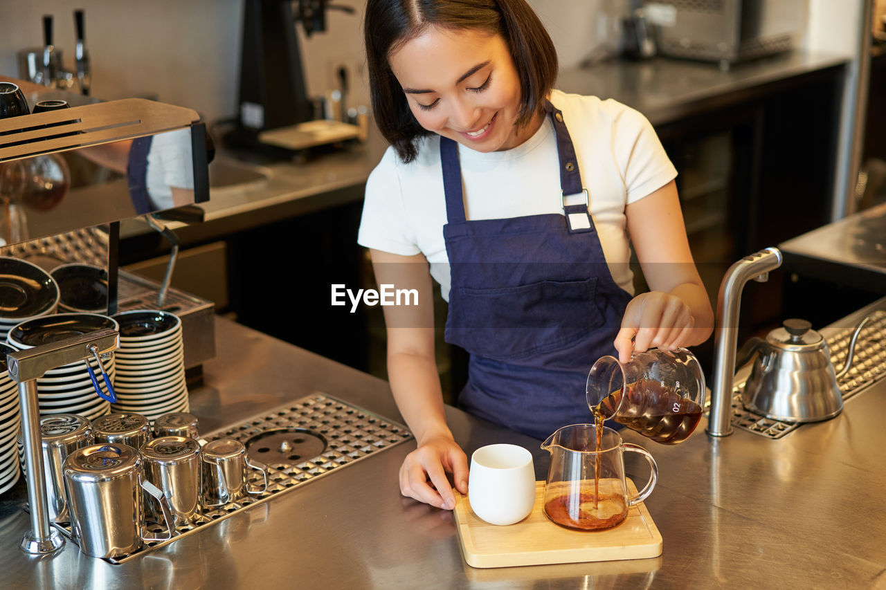 side view of woman preparing food at table