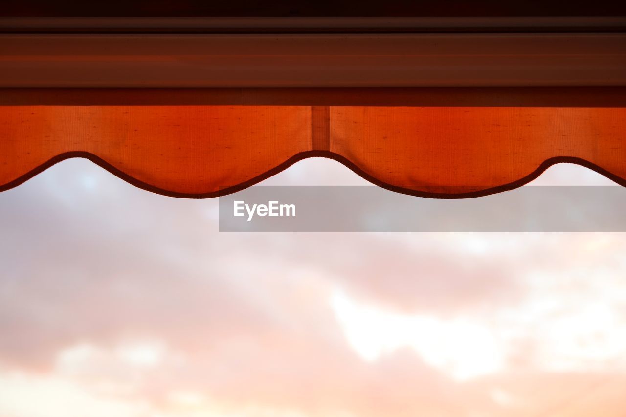 CLOSE-UP OF SUNGLASSES AGAINST SKY