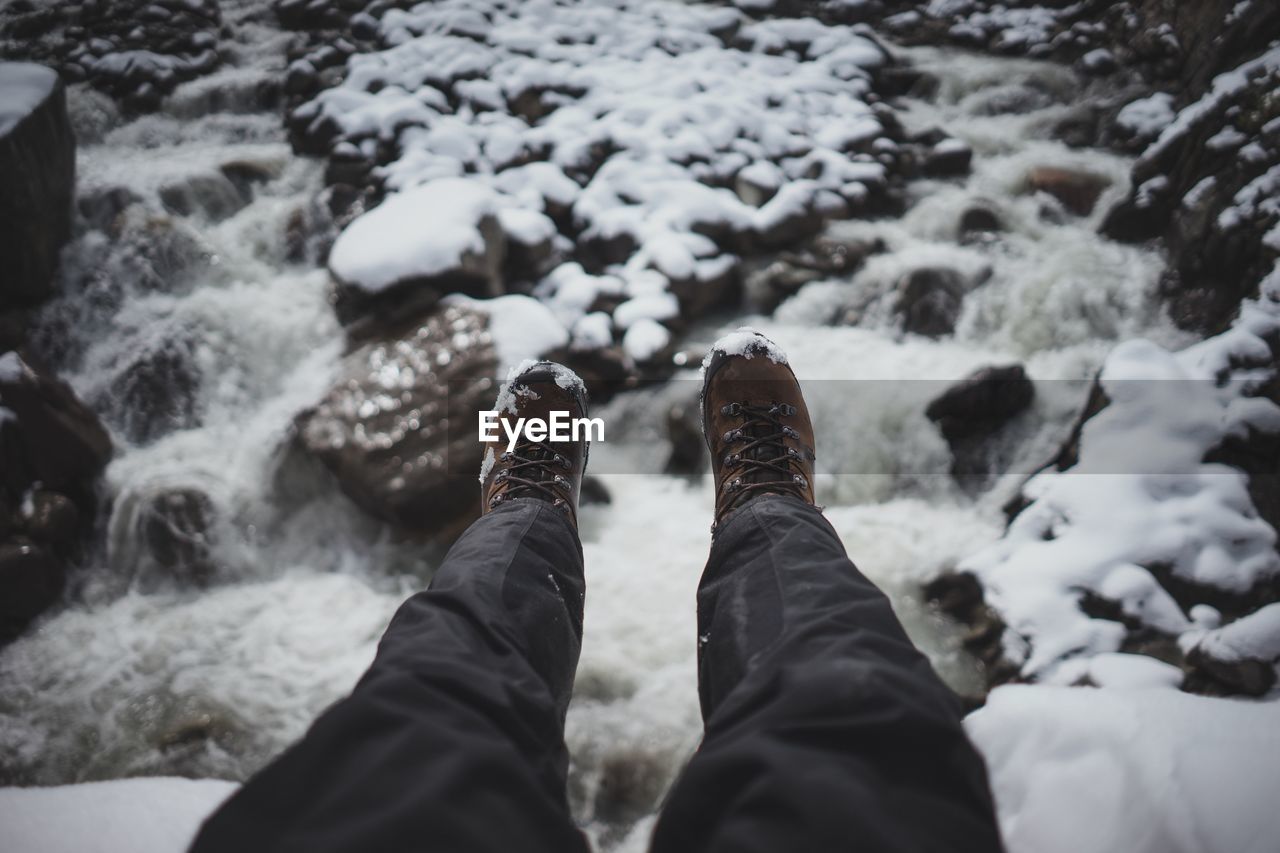 Low section of man over frozen river