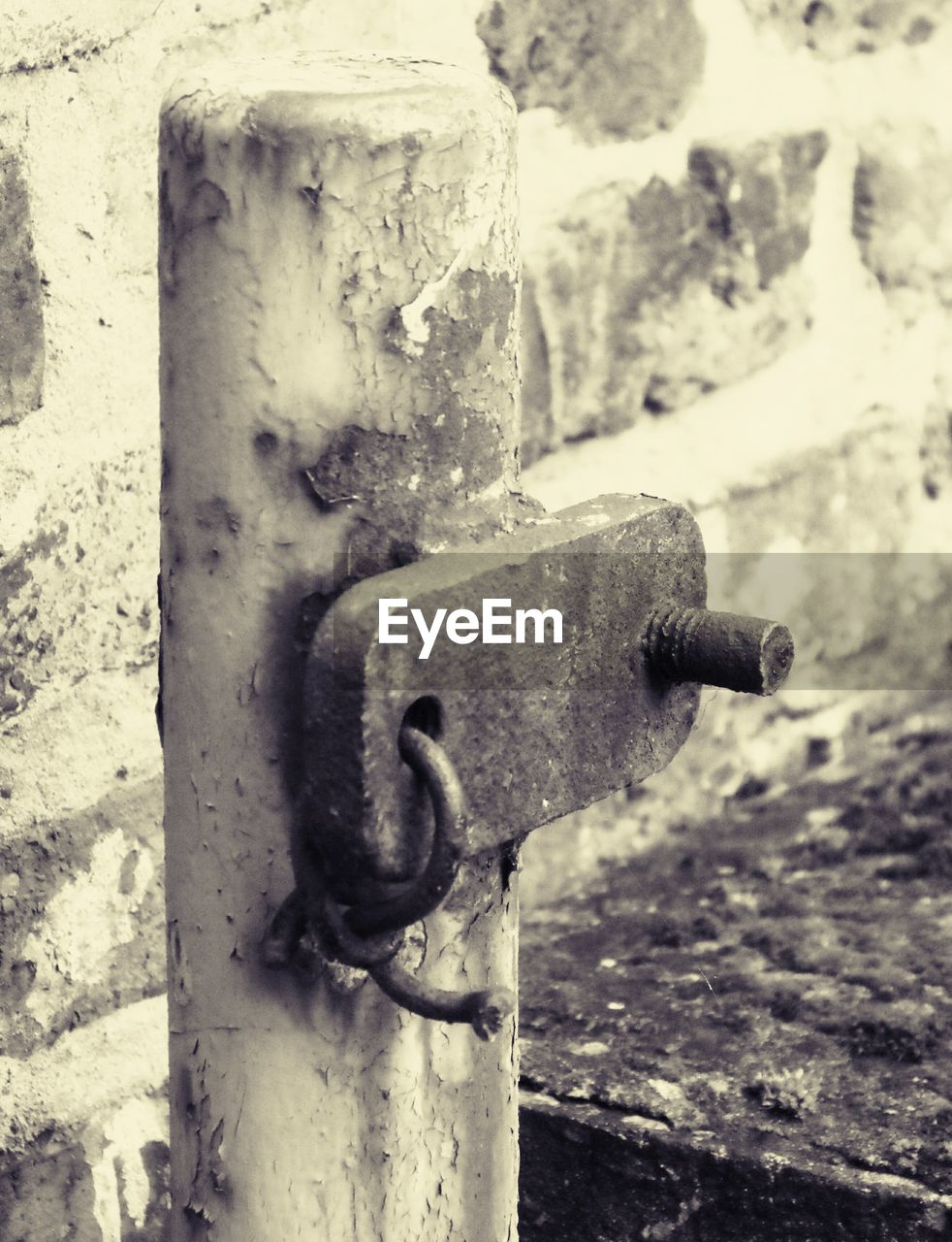 CLOSE-UP OF FIRE HYDRANT AGAINST WALL