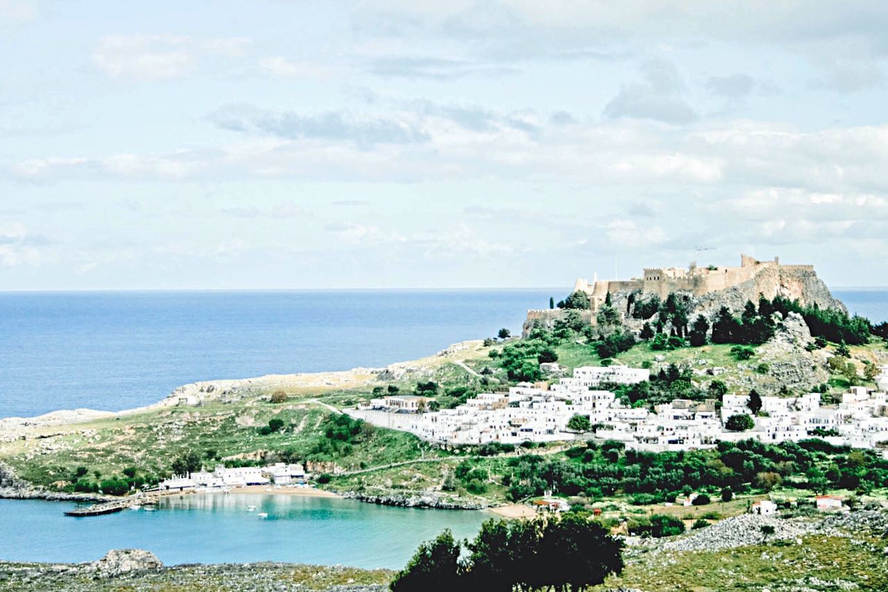 SCENIC VIEW OF SEA WITH MOUNTAIN RANGE IN BACKGROUND