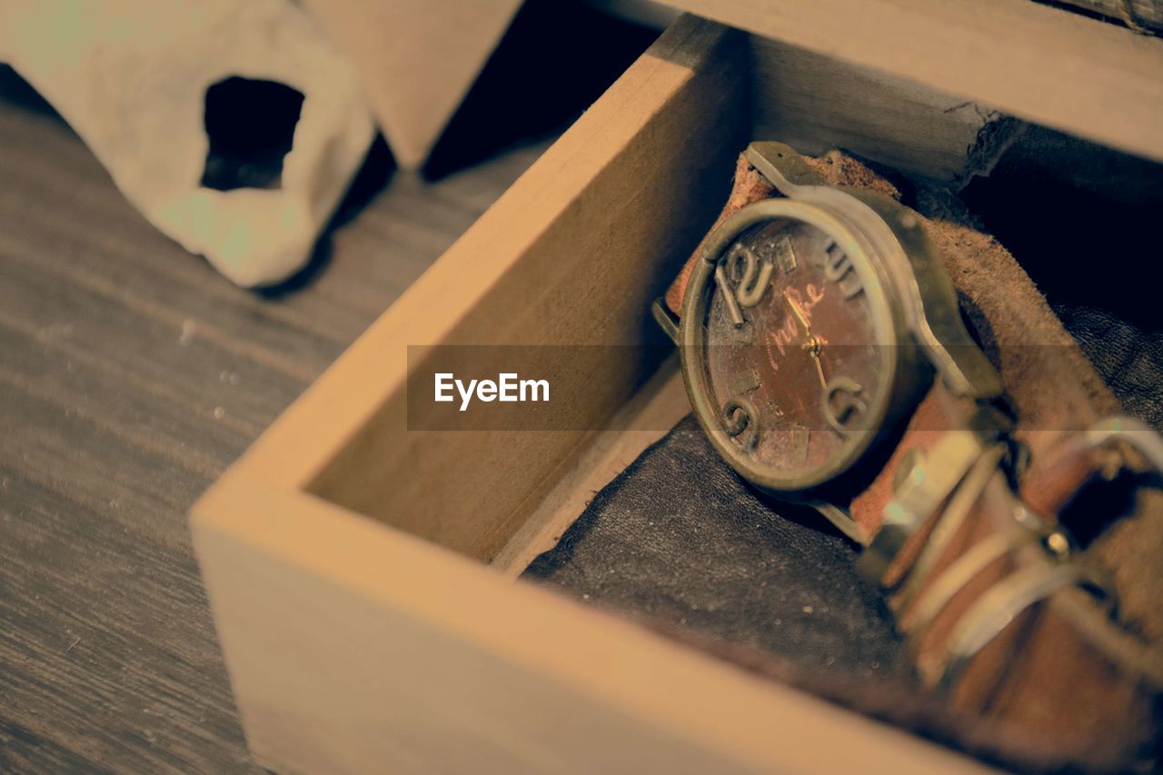 High angle view of antique watch in wooden box at shop