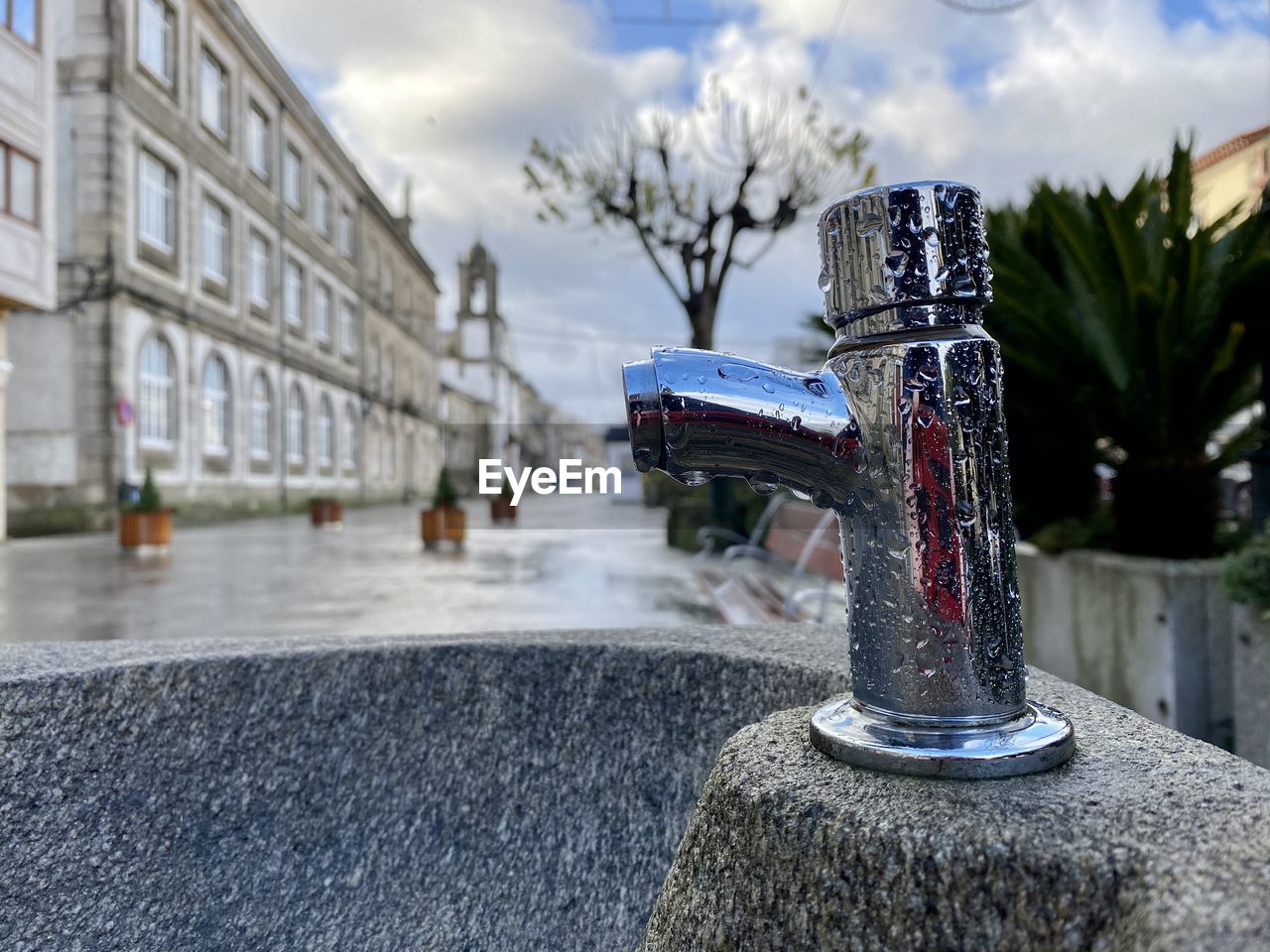 CLOSE-UP OF FOUNTAIN AGAINST BUILDING