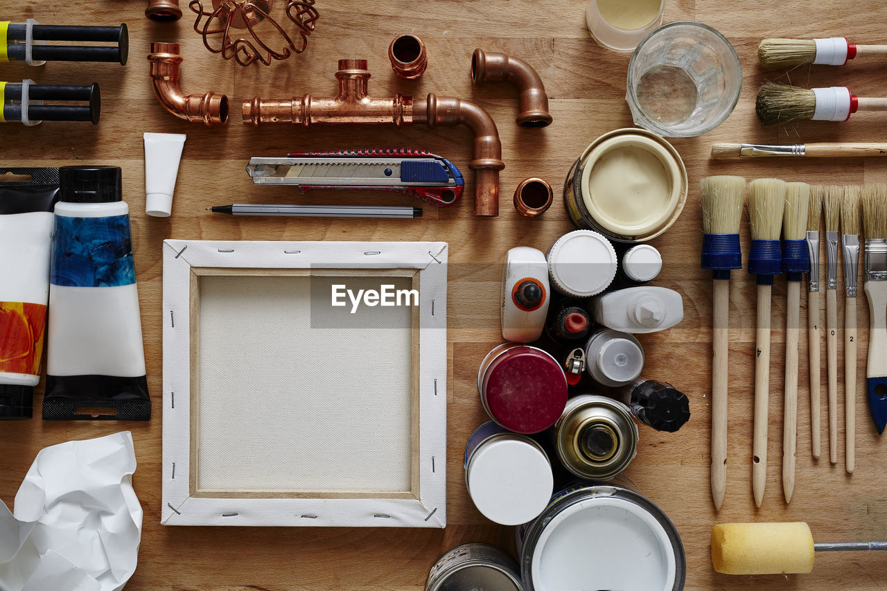 Directly above shot of work tools and plumbing equipment on wooden table