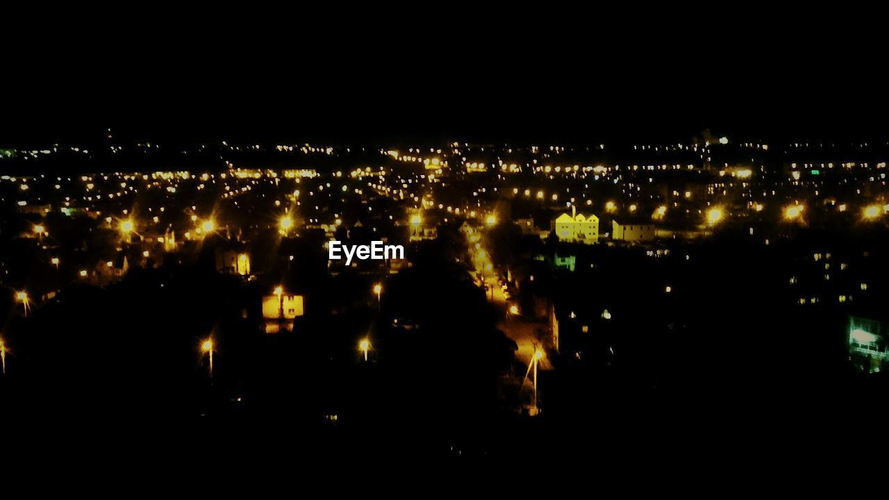 VIEW OF ILLUMINATED CITYSCAPE AT NIGHT