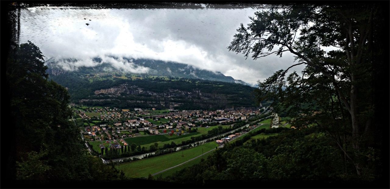 SCENIC VIEW OF VILLAGE AGAINST CLOUDY SKY