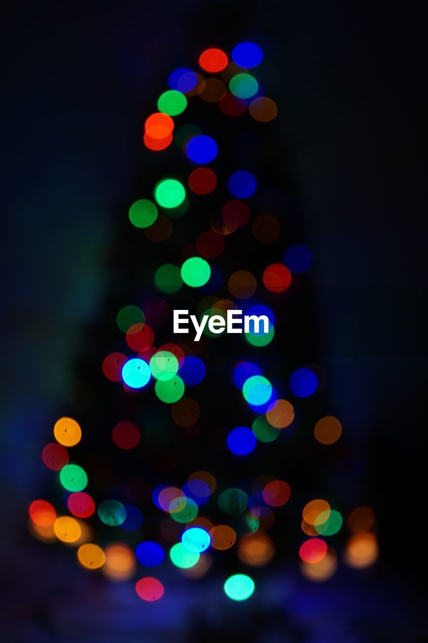 Defocused image of illuminated christmas tree