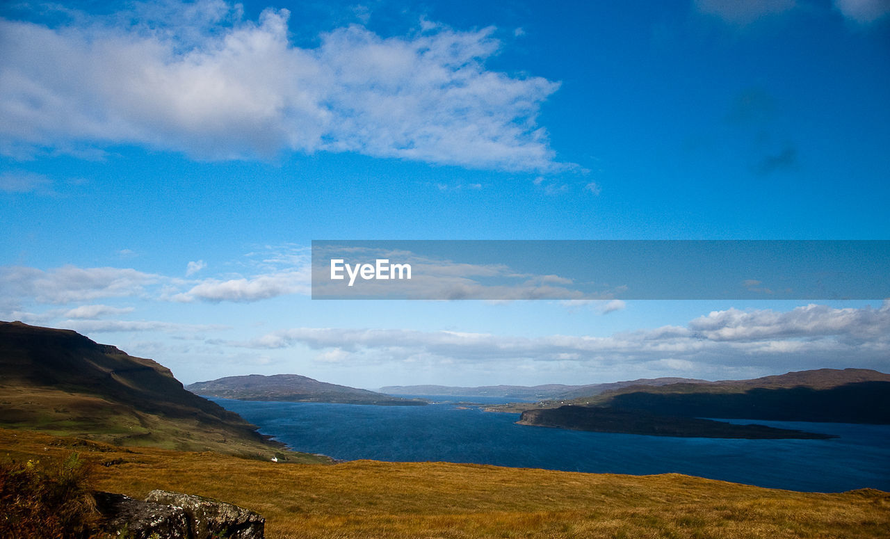 Scenic view of mountains against cloudy sky