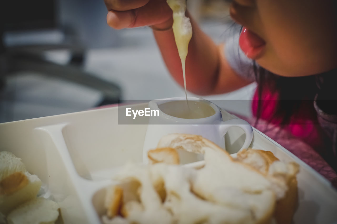 Close-up of girl eating bread