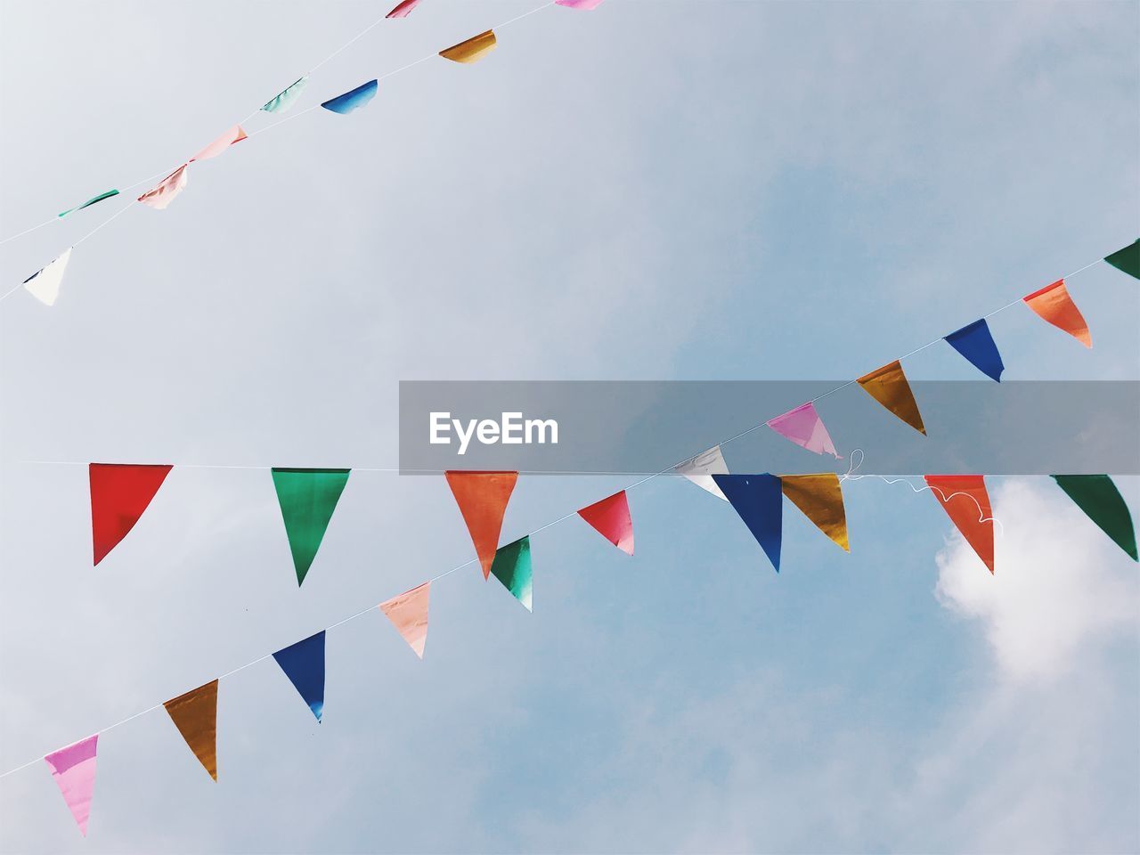 Low angle view of flags against sky