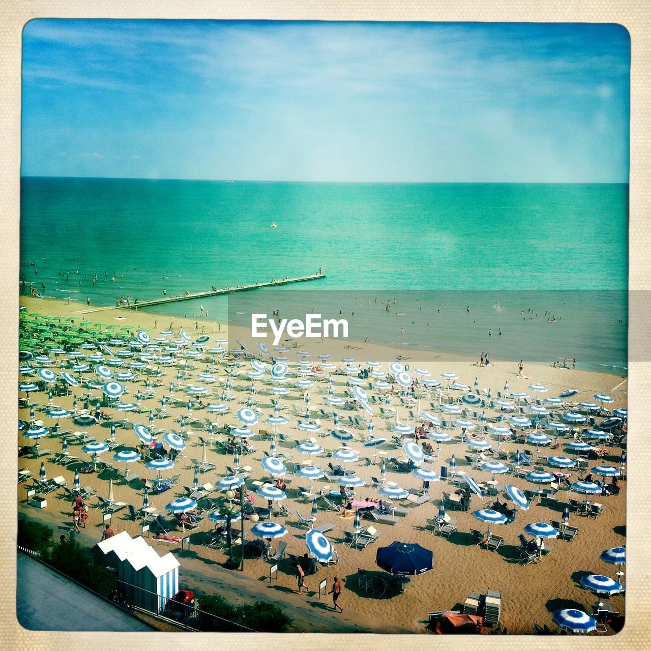 High angle view of parasols at sea shore against sky