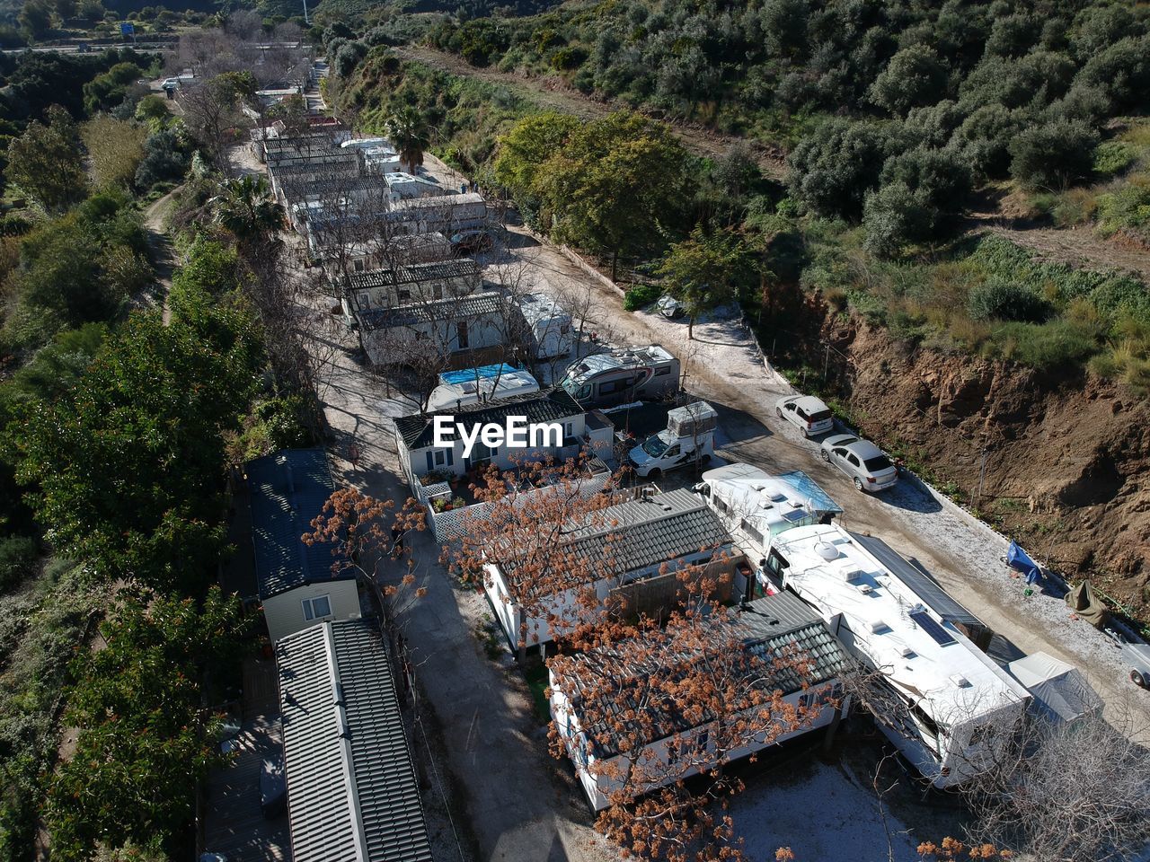 HIGH ANGLE VIEW OF OLD BUILDING BY TREES