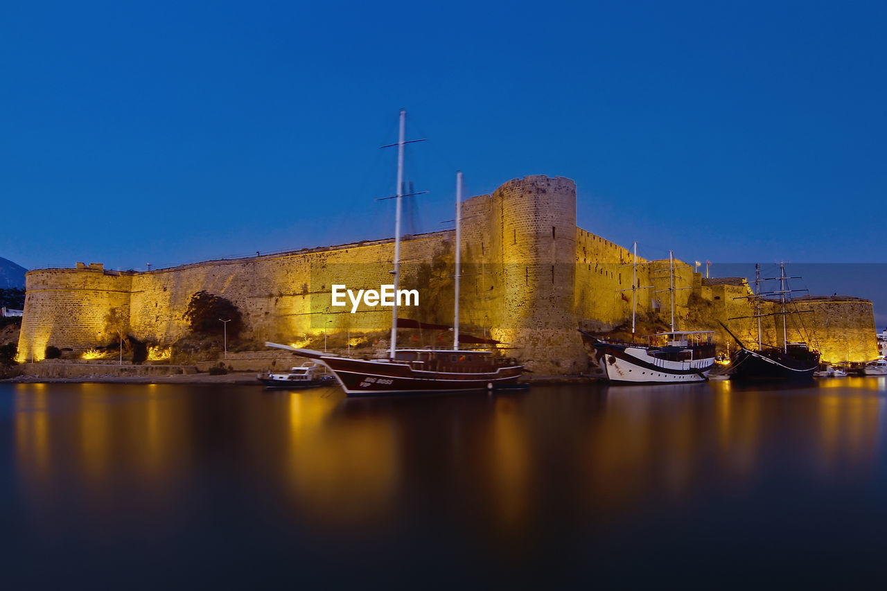 SAILBOATS MOORED ON BUILDING AGAINST CLEAR SKY