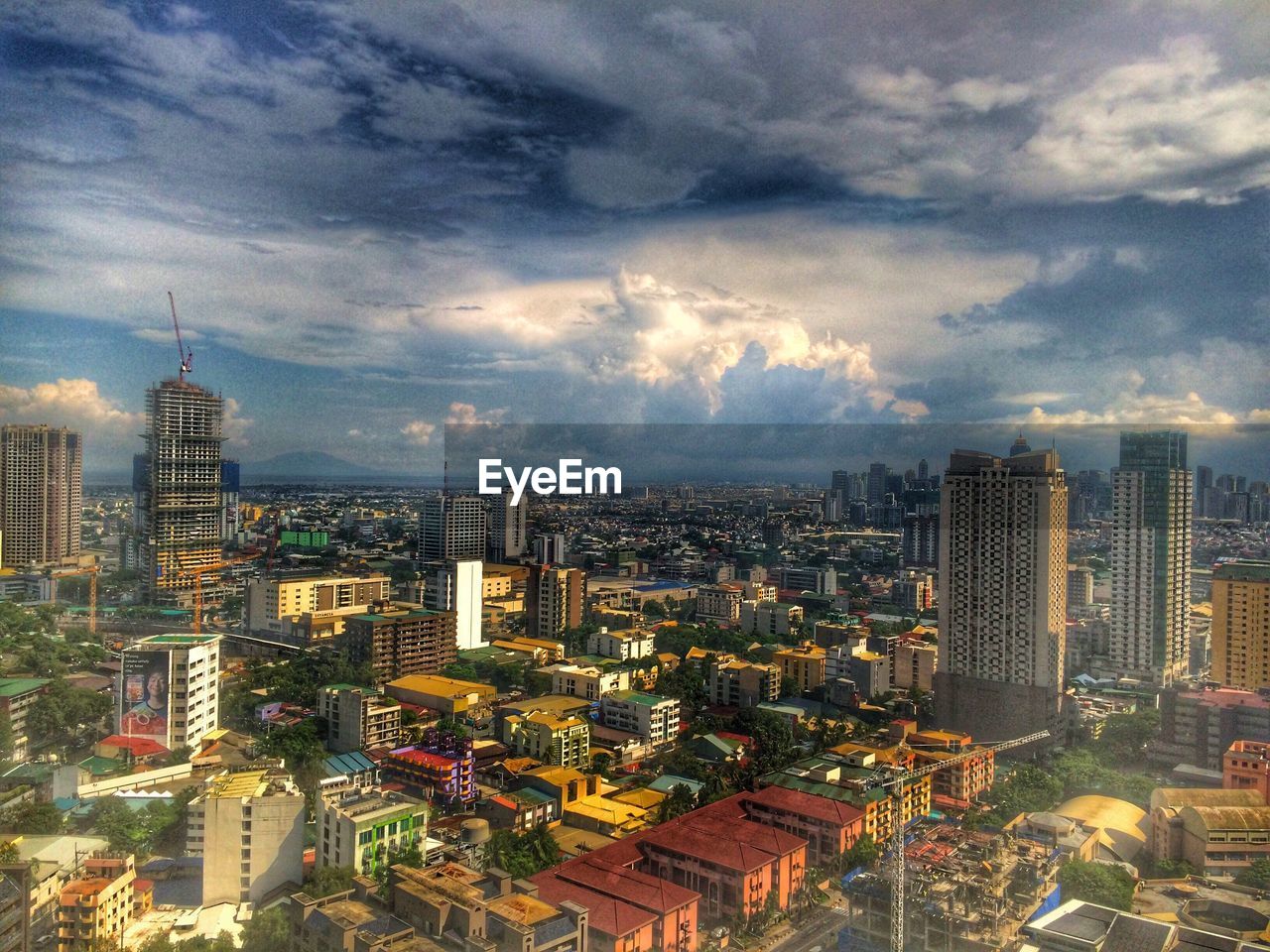 Cityscape against cloudy sky