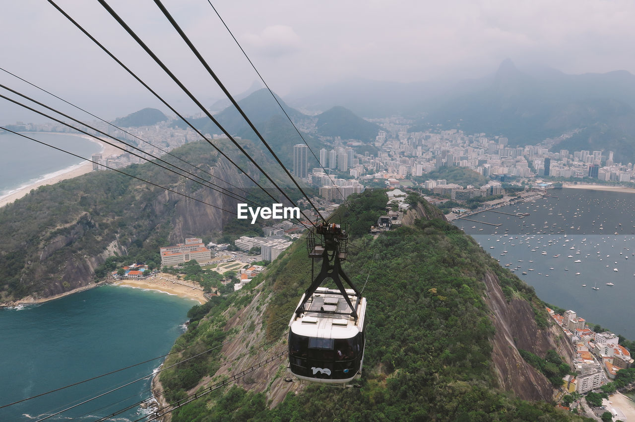 Overhead cable car over mountain and city