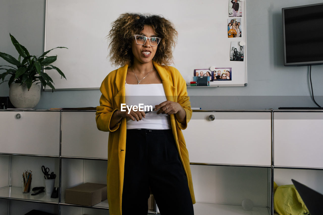 Female business professional talking during meeting at office