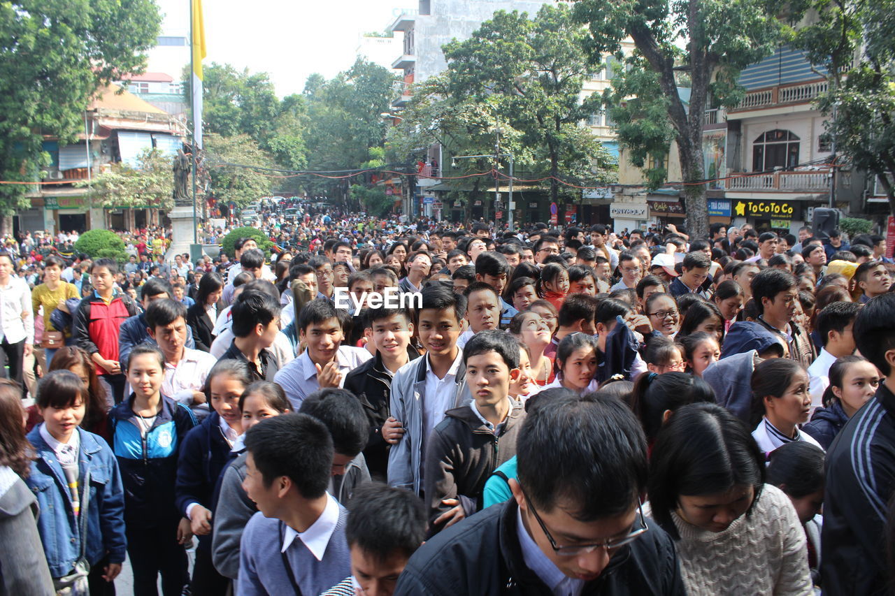 HIGH ANGLE VIEW OF PEOPLE LOOKING AT CITYSCAPE