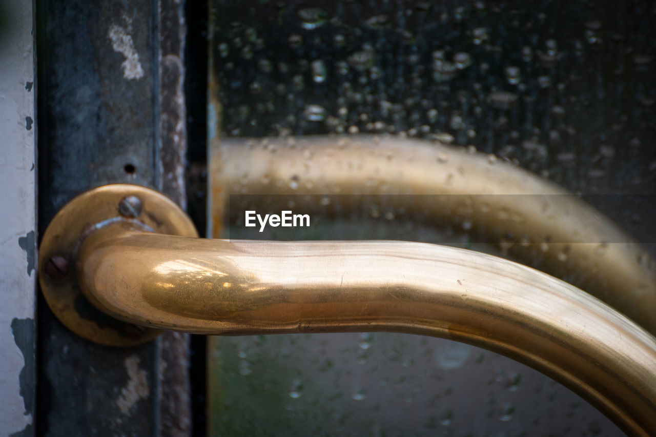 Close-up of water drops on metal door