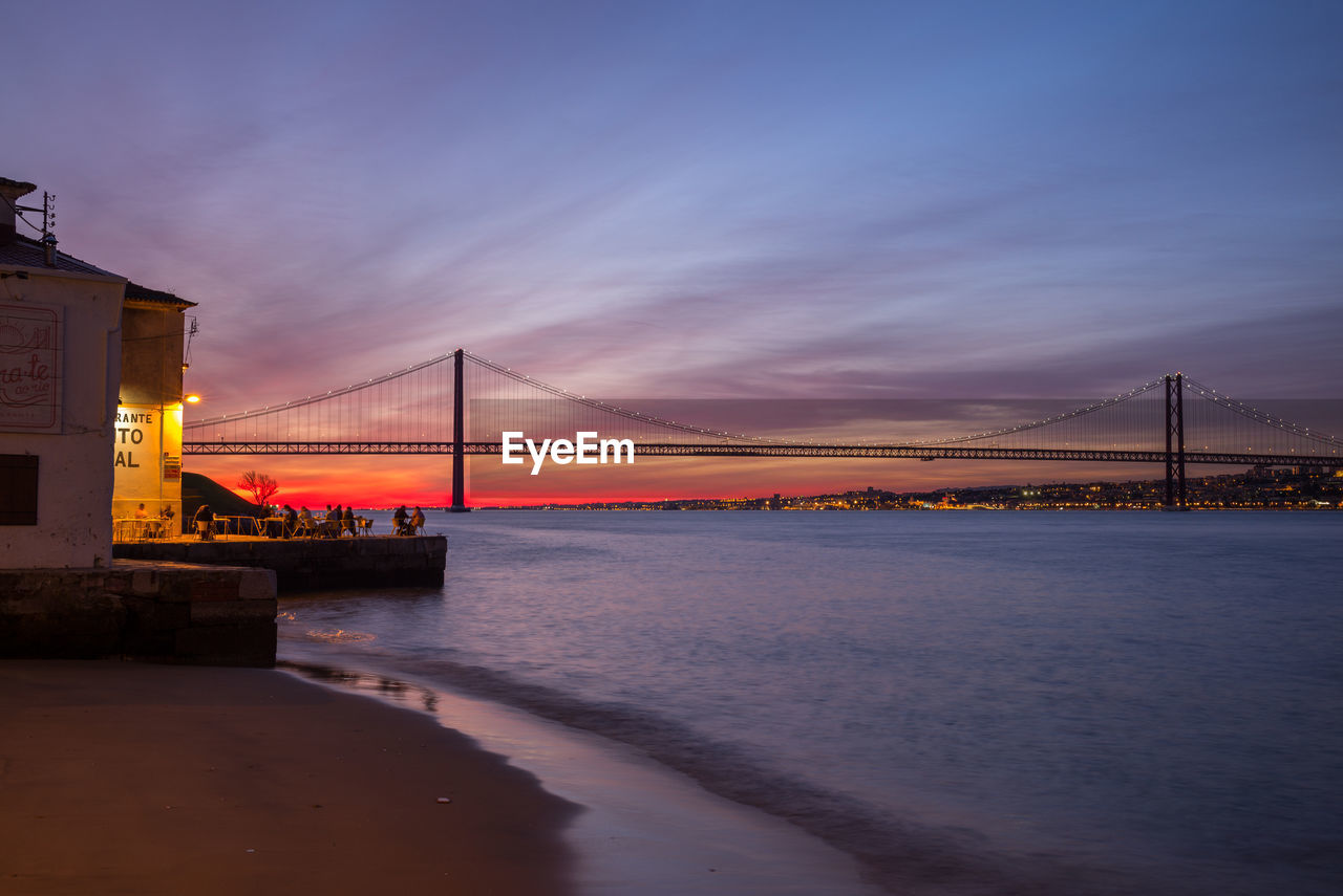 VIEW OF SUSPENSION BRIDGE OVER RIVER